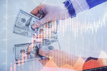 Multi exposure of financial graph drawing hologram and USA dollars bills and man hands. Analysis concept.