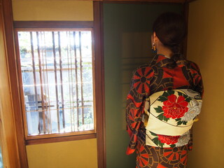 An Asian woman wearing a traditional Japanese kimono at Japanese-style restaurant, Kyoto, Japan