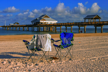 Clearwater beach at sunrise, beach chairs facing the sea in Clearwater Beach