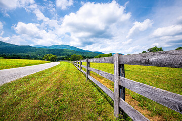 Farm road fence closeup in Roseland, Virginia near Blue Ridge parkway mountains in summer with...