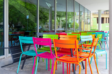 Deserted chairs and tables in front of a café which is closed due to a coronavirus