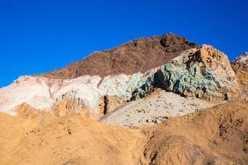 Stunning landscape view of the colorful rock formations of Artist's Pallete during susnet in Death Valley National Park (California).