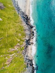 Aerial view of Lofoten islands, Northern Norway, Kvalvika beach, during sunset.