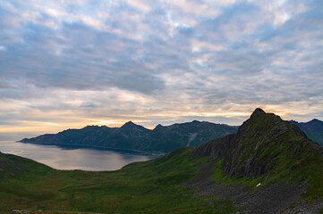 Fototapeta na wymiar Sunset over Senja island in Northern Norway , mount Hesten in the middle of frame. (high ISO image)