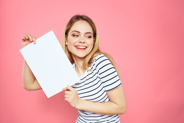 woman holding white sheet in her hands striped t-shirt emotions pink background