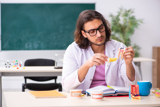 Young male dentist in the classroom