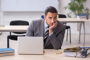 Young male employee with snake in the office