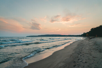 Sandy beach at sunset with clouds lake Superior Ontario Canada