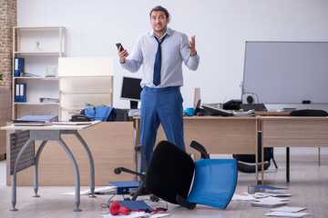 Young male employee unhappy with excessive work