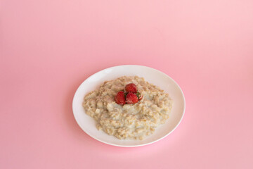 Oatmeal porridge with fresh frozen berries. Healthy breakfast.