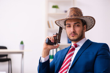 Young businessman cowboy working in the office