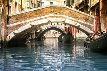 Fototapeta na wymiar Bridge over canal in Venice Italy with gondolas