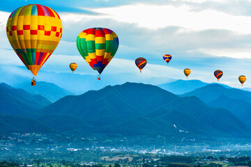 Colorful hot air balloons flying over mountain at  pai mae hong son Thailand.