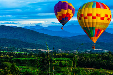 Colorful hot air balloons flying over mountain at  pai mae hong son Thailand.