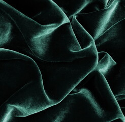 velvet texture green color background, expensive luxury fabric, material,  wallpaper. copy space