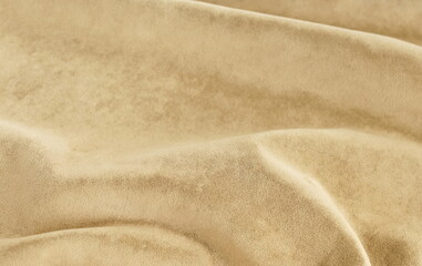 Fototapeta na wymiar velvet texture beige color background, expensive luxury fabric, material, wallpaper. copy space