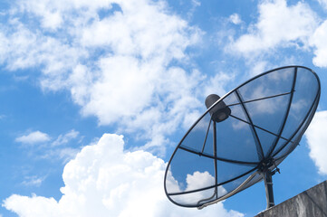 A single black communication satellite dish against the blue sky