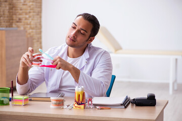 Young male dentist working in the clinic
