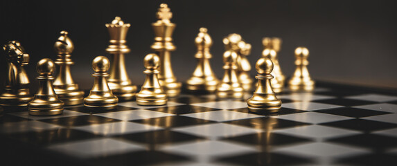 The golden chess standing in front of team. Concepts of leadership and business strategy and risk management.