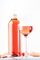Rose wine glass with bottle on the gray table. Pink rosado, rosato or blush wine tasting in wineshop, bar concept. Copy Space