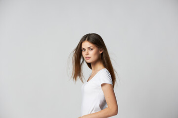 woman a white T-shirt with loose hair cropped view