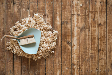 Broom and dustpan on wooden floor. Cleaning concept