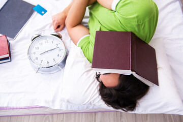 Young male student preparing for exams at home