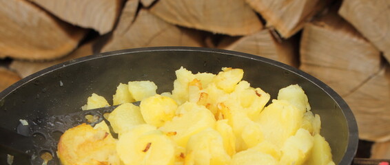 fresh fried potatoes with onions in a pan