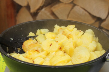 fresh fried potatoes with onions in a pan