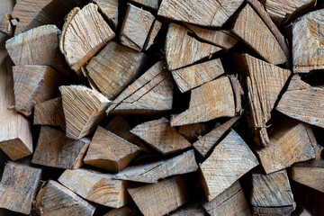 Firewood is stacked one on top of the other. Background texture.
