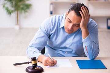Young man in courthouse in divorcing concept