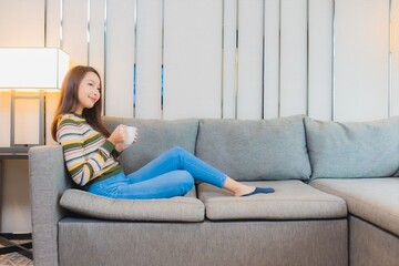 Obraz premium Portrait beautiful young asian woman smile relax on sofa