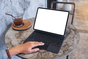 Mockup image of a woman touching on tablet touchpad with blank white desktop screen as a computer pc