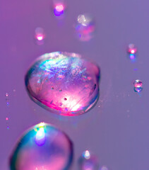 Blue drops of water on a pink background.