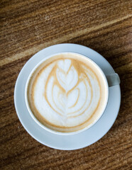Cappuccino coffee is served clean on the wooden table. Hot drinks are served at the coffee shop. 