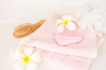 Obraz na płótnie Canvas comb terry cloth and soap health care body skin cleaning a bath on background white wood