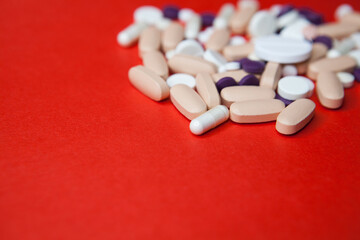 Various pills macro on red background. Top view