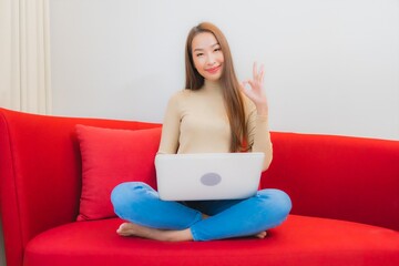 Portrait beautiful young asian woman use computer laptop on sofa