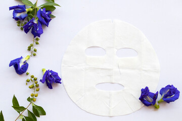 natural aroma sheet mask for skin face from herbal blue flower butterfly pea essence face mask on background white