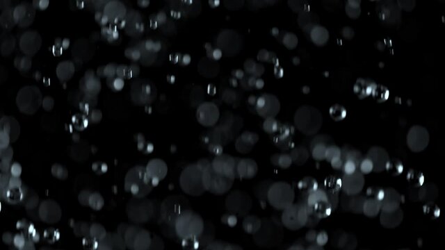Super Slow Motion Shot of Falling Water Drops Isolated on Black Background at 1000 fps.