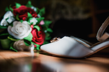 gold wedding rings are in a beautiful composition with a wedding bouquet