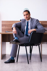 Fototapeta premium Young male employee working in the office