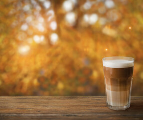 Autumn latte coffee on  wooden table, autumn