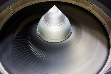 running jet engine turbine with fast turning fan blades - close-up