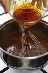 Pouring golden syrup into chocolate mixture. Making Chocolate, Pear and Pecan Pie Series.