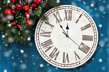 Fototapeta na wymiar New Year and Christmas background with clock and fir tree branches. Flat lay
