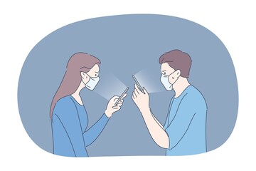 Protection, communication, infection, coronavirus concept. Couple man and woman wearing medical face masks communicate in social media online togehter. Stay home during COVID19 disease quarantine.