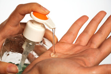 Applying disinfectant gel on hand, isolated on white.