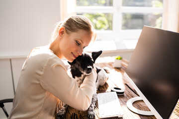 Woman Hugging Dog In Home Office