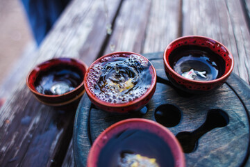 Tea pours from a teapot into a cup, tea ceremony.